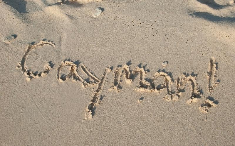 Cayman Island lettering on sand